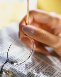 Holding Glasses over Bible